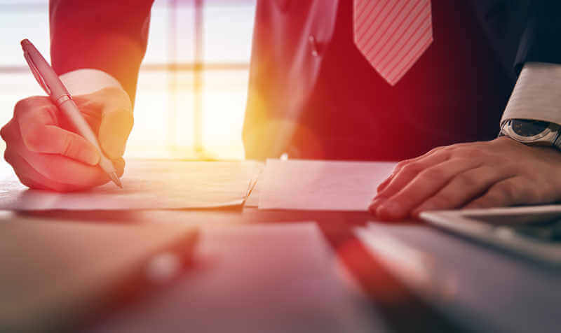 businessman signing documents