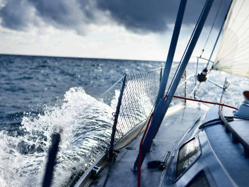 Stormy weather on the sea. A view from the sailboat's deck to th